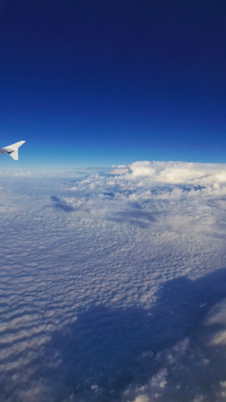 sky, beauty in nature, scenics - nature, blue, cloud - sky, airplane, tranquil scene, nature, tranquility, aerial view, no people, air vehicle, cloudscape, flying, day, outdoors, copy space, idyllic, transportation, mountain, meteorology, softness, above