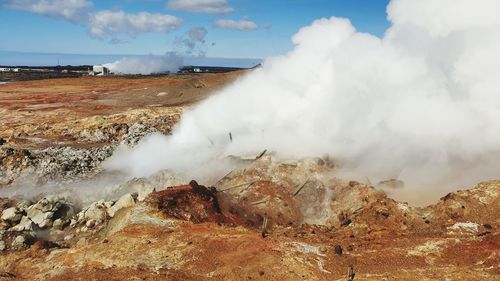 Smoke emitting from volcanic mountain against sky