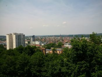 High angle view of trees and cityscape against sky