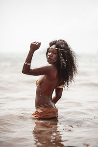 Portrait of tribal woman standing in sea