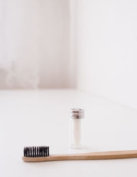 Zero waste dental floss and eco toothbrush on the white table