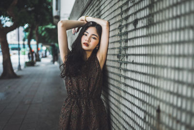 Portrait of a young woman standing in the dark