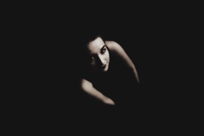 Portrait of man against black background