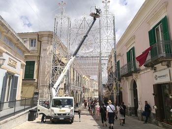 People in city against sky