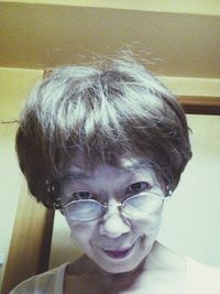 Close-up portrait of boy wearing eyeglasses at home