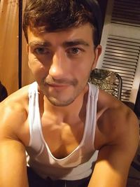 Portrait of young man sitting at home