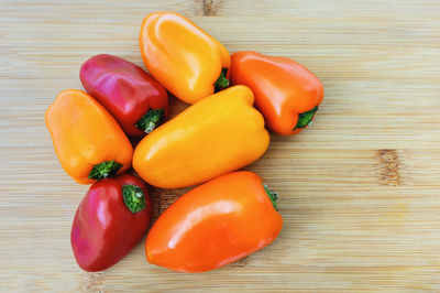 High angle view of bell peppers on wooden table