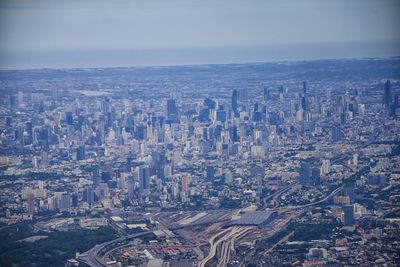 High angle view of modern buildings in city against sky