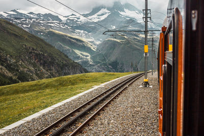 Railway and red train close up, gornergrat mountains. zermatt, swiss alps. adventure in switzerland.