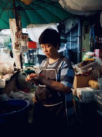 Woman standing at market stall
