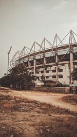 Abandoned building on field against sky