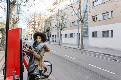 Portrait of woman riding motorcycle on road