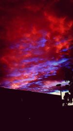 Silhouette of landscape against cloudy sky