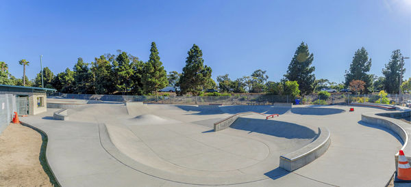View of skateboard park against clear blue sky