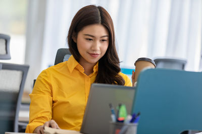 Businesswoman wearing mask working in office