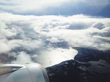 Cropped image of airplane wing over landscape