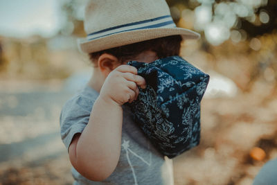 Close-up of baby boy holding bag