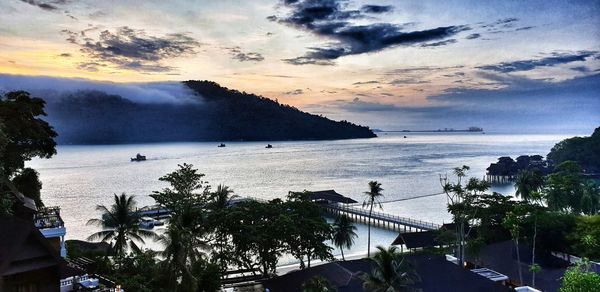 High angle view of bay against sky at sunset