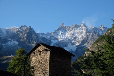 Scenic view of mountains against clear blue sky