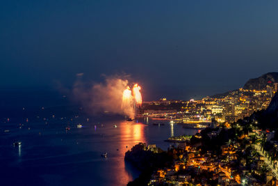 High angle view of city lit up at night