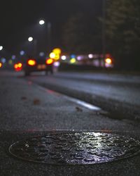 Close-up of wet road at night