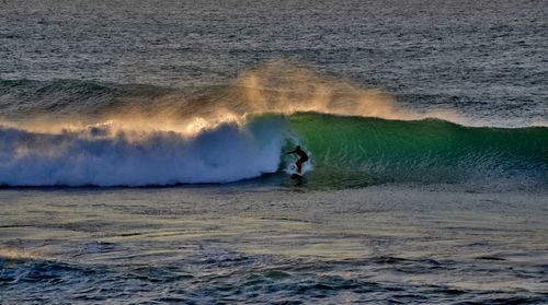 Man surfing at sunset