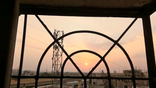 Scenic view of bridge in city against sky during sunset