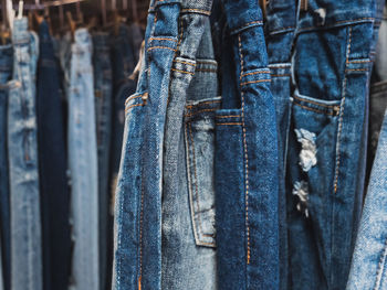 Close-up of clothes hanging on blue wall