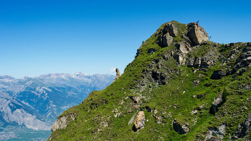 Scenic view of mountains against clear blue sky