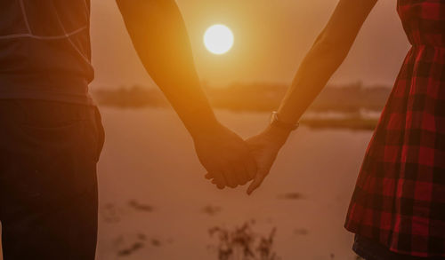 Silhouette people against sky during sunset