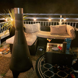 Table and chairs in illuminated room at night