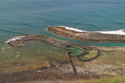 High angle view of rusty metal on sea shore