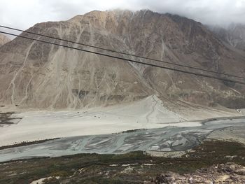 Aerial view of bridge over mountain against sky