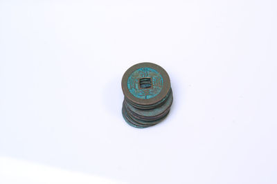 High angle view of coins on white background