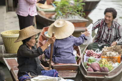 Vendors selling food at floating market