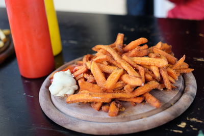 High angle view of french fries on wooden tray