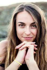 Close-up portrait of smiling woman outdoors