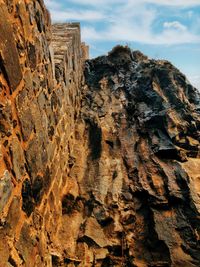 Low angle view of rock formation against sky