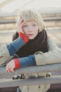 Portrait of smiling girl playing on slide at playground