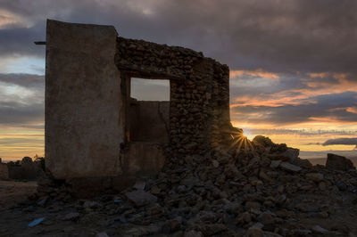 Old ruin building against sky during sunset