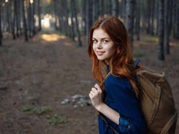 Portrait of smiling young woman standing outdoors