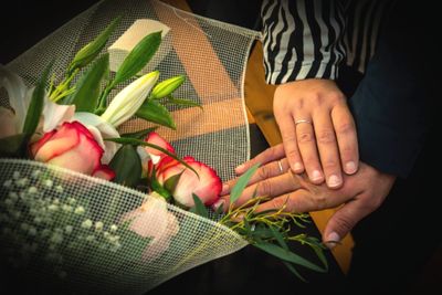 Midsection of woman holding flower bouquet