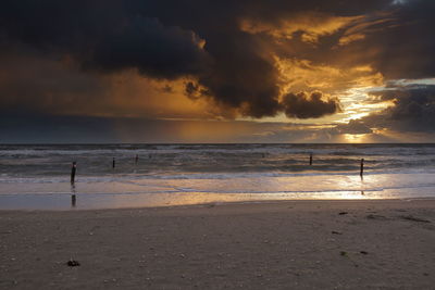 Scenic view of beach against sky during sunset
