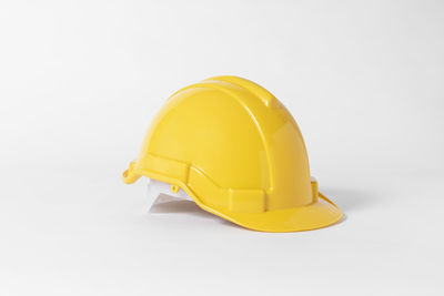 Close-up of yellow hat against white background