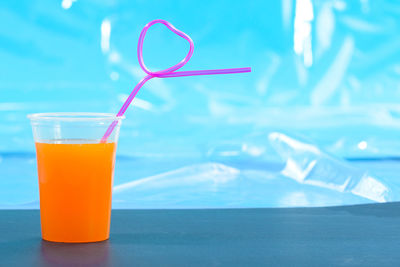 Close-up of orange juice on table