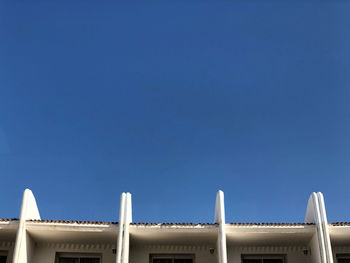 Low angle view of building against clear blue sky