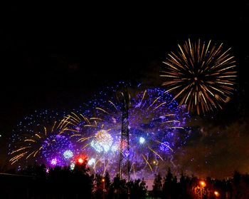 Low angle view of firework display at night