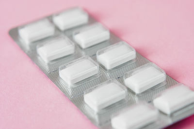 Close-up of blister pack on pink background