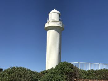 Low angle view of tower against blue sky