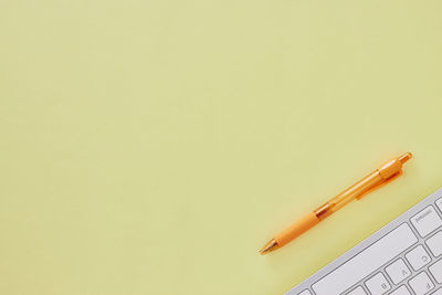 High angle view of colored pencils against white background
